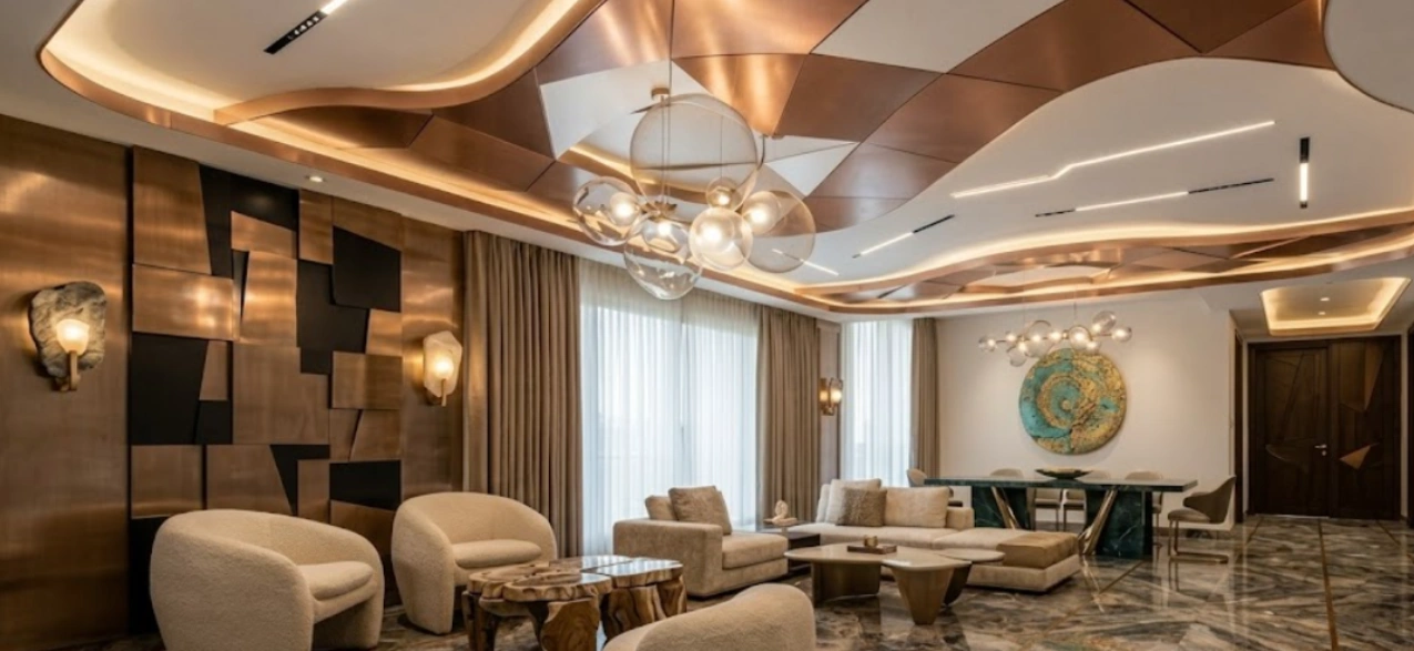 Curved organic wave false ceiling with copper panels and cove lighting in a Delhi NCR apartment